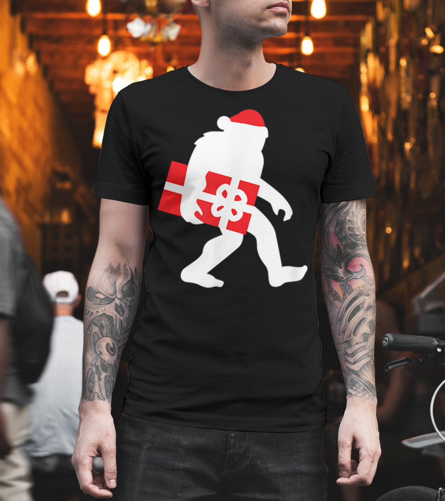 Nice Bigfoot Carrying Christmas Gift in Santa Hat T-Shirt