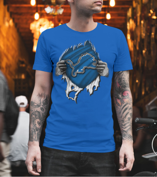 Torn DETROIT LIONS Logo Revealed Through Ripped Blue Fabric T-Shirt Torn DETROIT LIONS Logo Revealed Through Ripped Blue Fabric T-Shirt
