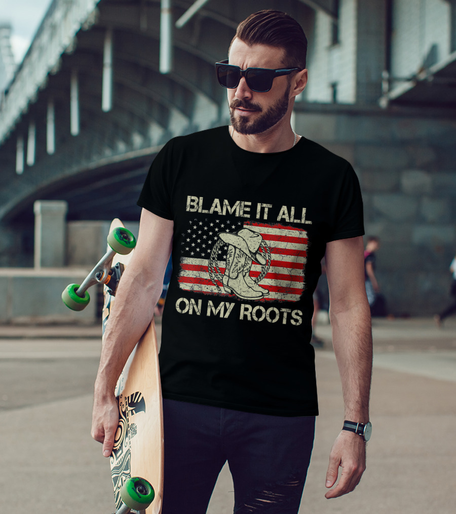 Blame It All On My Roots Cowboy Hat Boots American Flag Background T-Shirt
