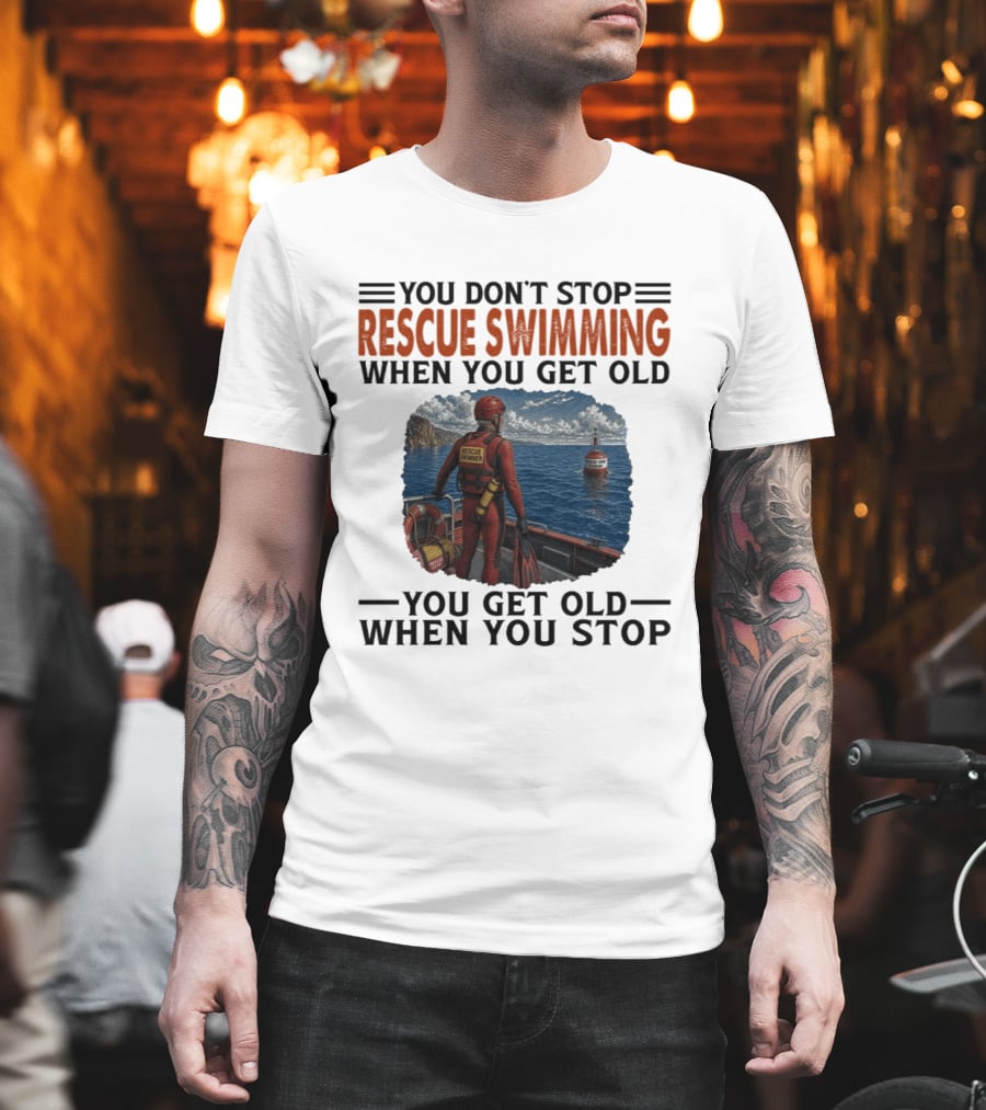 You Don't Stop Rescue Swimming When You Get Old You Get Old When You Stop Rescue Swimmer Standing On Boat Near Lighthouse T-Shirt