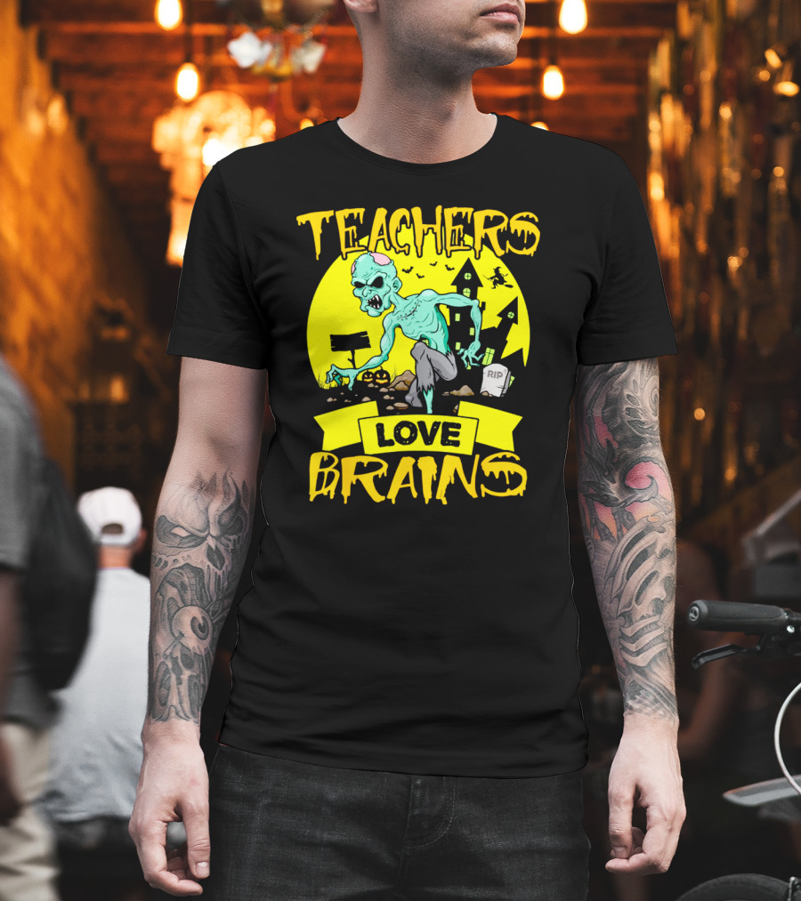 Teachers Love Brains Zombie Halloween Theme With Haunted Houses And Graveyard Background T-Shirt