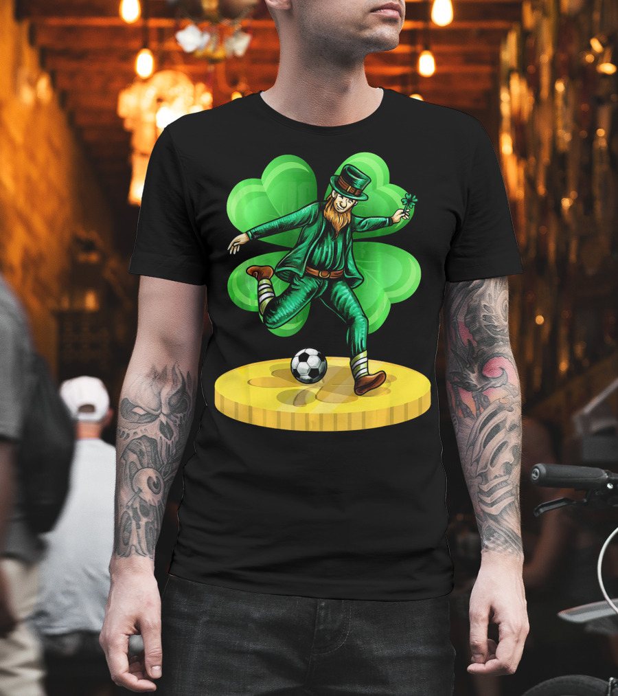 Leprechaun Kicking Soccer Ball On Gold Coin With Shamrock Background T-Shirt