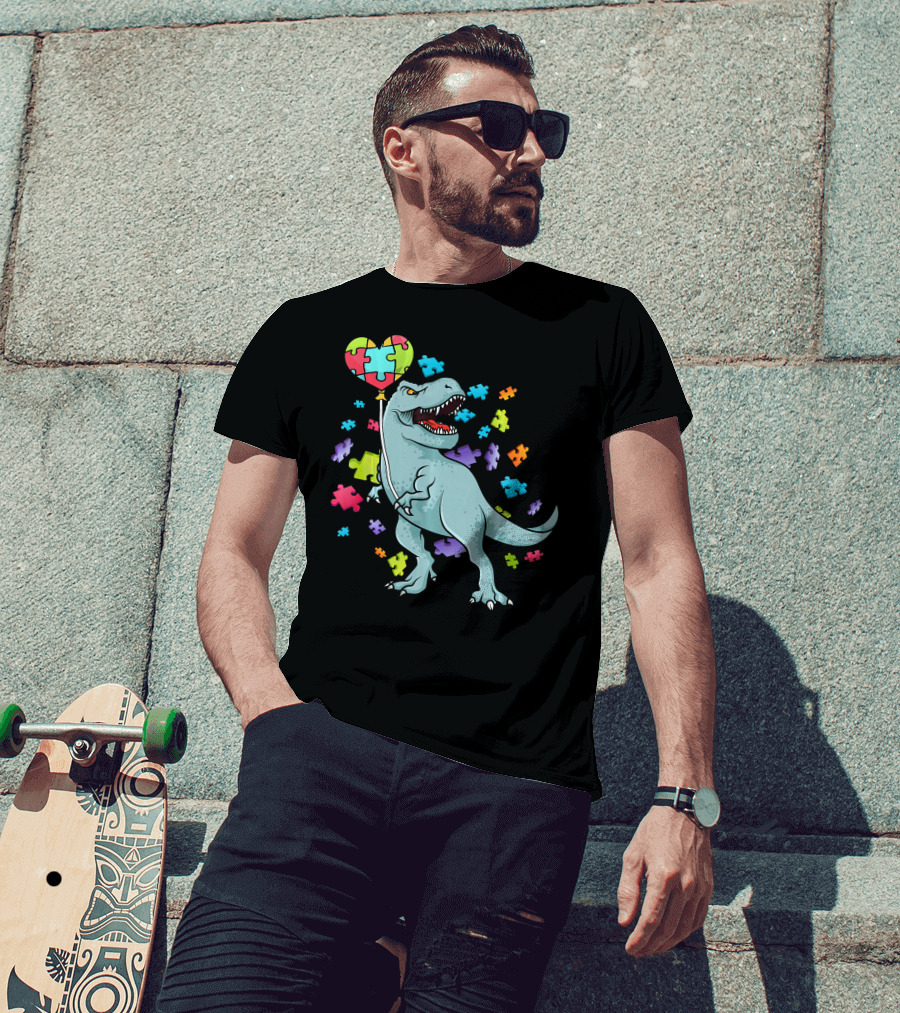 Autism Awareness Dinosaur With Puzzle Heart Balloon And Colorful Puzzle Pieces T-Shirt