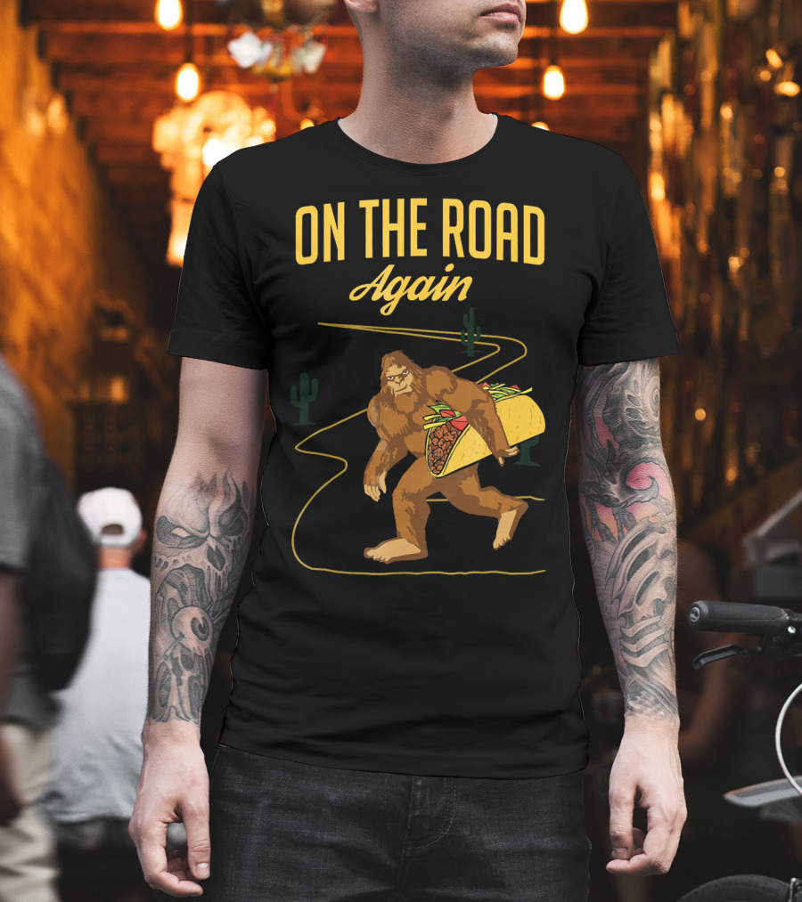 ON THE ROAD AGAIN Smirk Bigfoot Sasquatch Carrying Taco T-Shirt